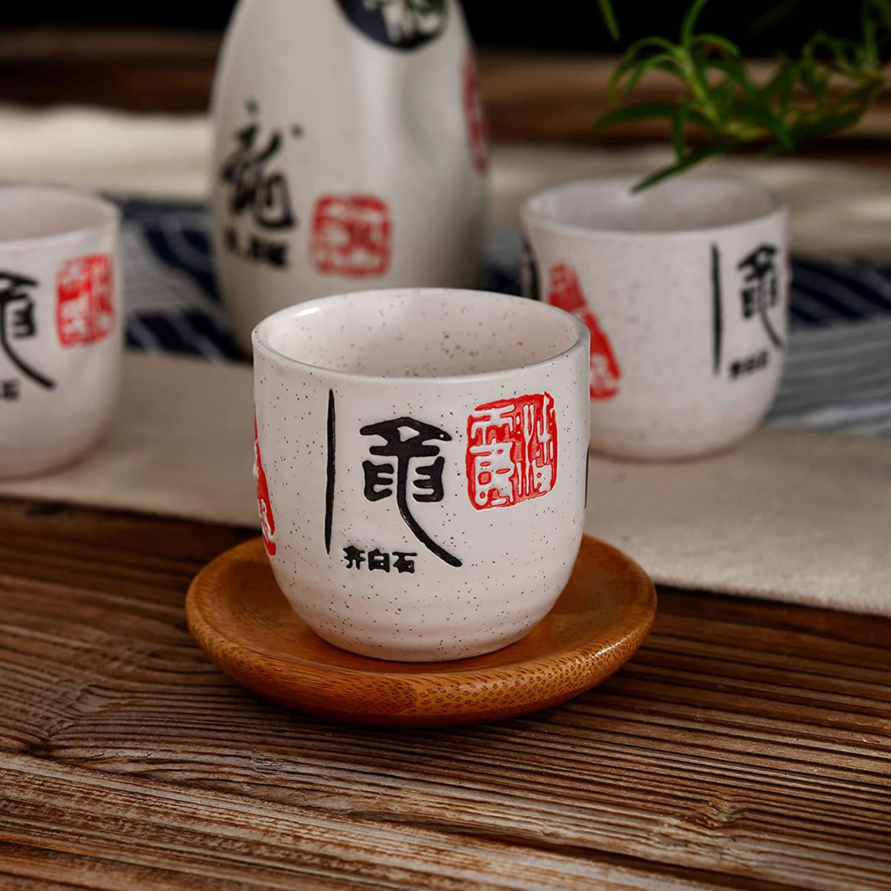 Poring Sake In Stoneware Sake Cups