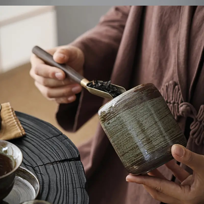 Putting Tea In Tea Ceremony Canister