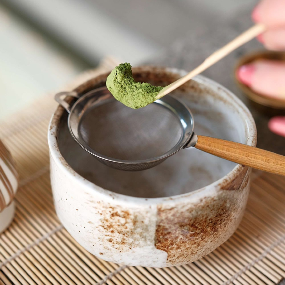 Straining Matcha In Wooden Strainer